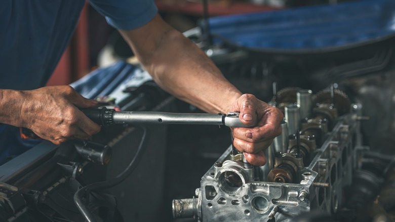 Mechanic using torque wrench