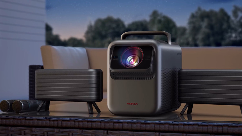Anker Nebula X1 Projector with additional speakers on an outdoor table