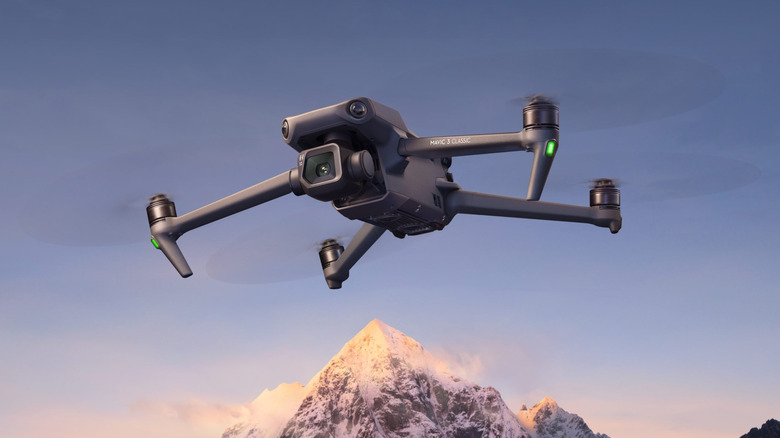 DJI Mavic 3 Classic flying through the air with a mountain in the background