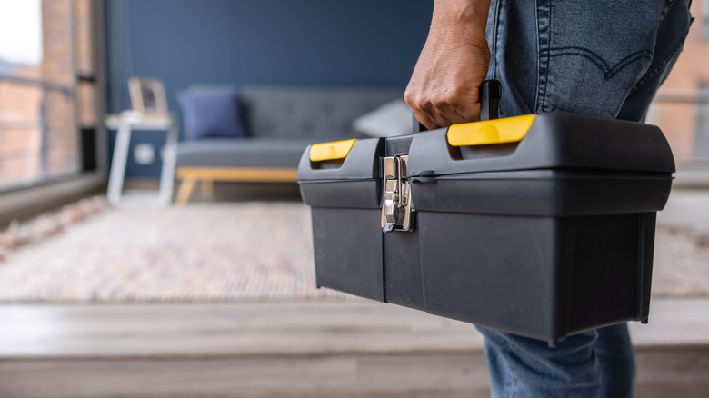 Person carrying toolbox