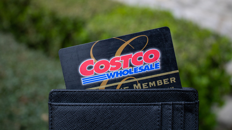a costco executive membership card is sticking out of a wallet