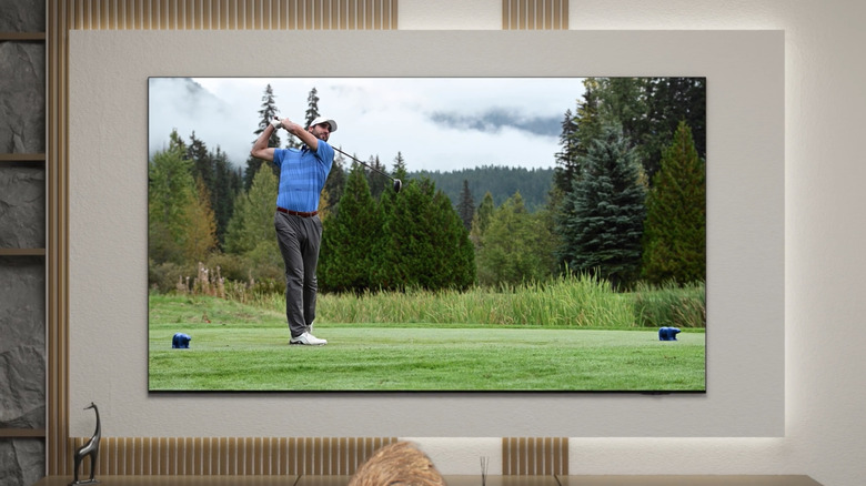 Samsung Crystal UHD TV mounted on wall in modern living space with bright lighting