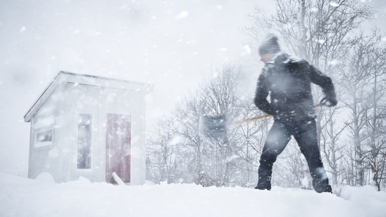 Person shoveling during a snow storm