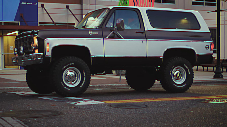 A brown and white Chevrolet K5 Blazer coupe SUV with a plastic roof.