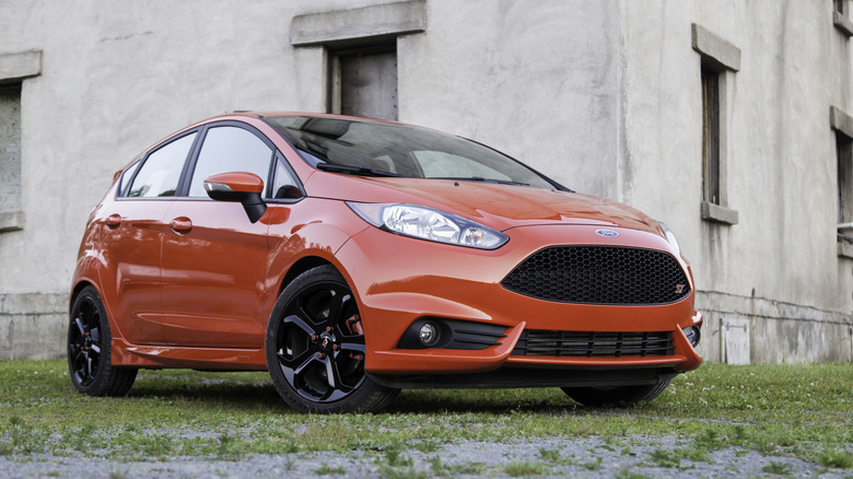 A red Ford Fiesta ST parked in front of a building