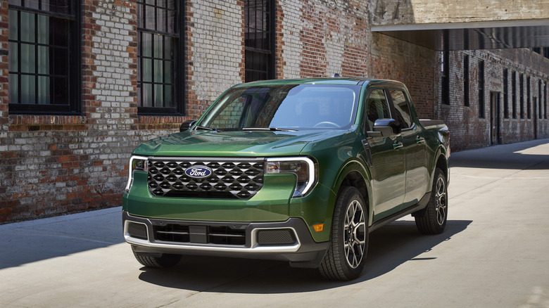 A green 2025 Ford Maverick in front a building