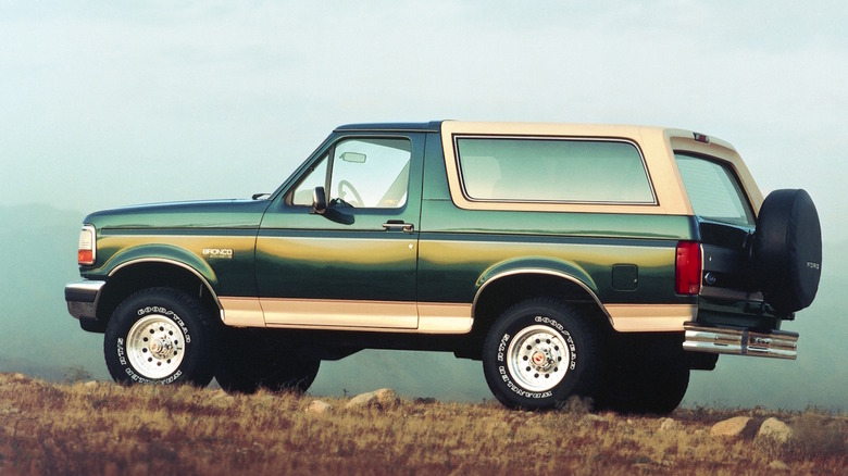 A green and tan 1993 Ford Bronco on a hilltop