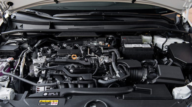The engine bay of a 2026 Toyota Corolla, showing the 2.0-liter, four-cylinder engine with a cover.