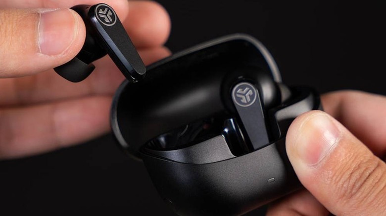 Close up of a person removing the JLab Go Pods ANC earbuds from their case.