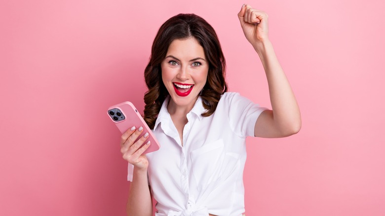 happy woman holding iPhone