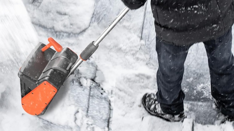 man using electric snow shovel