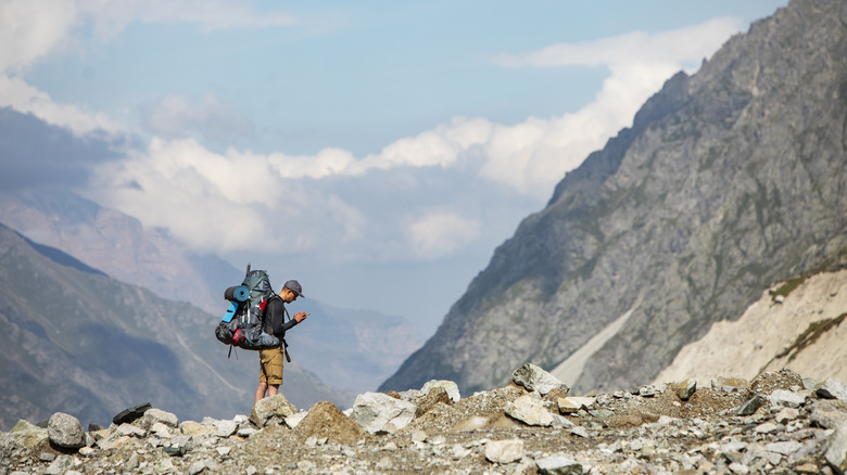 man checking map in mountains