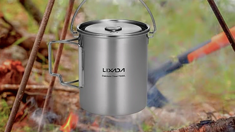 The LIXADA Camping Cup Pot cooking over na open flame.