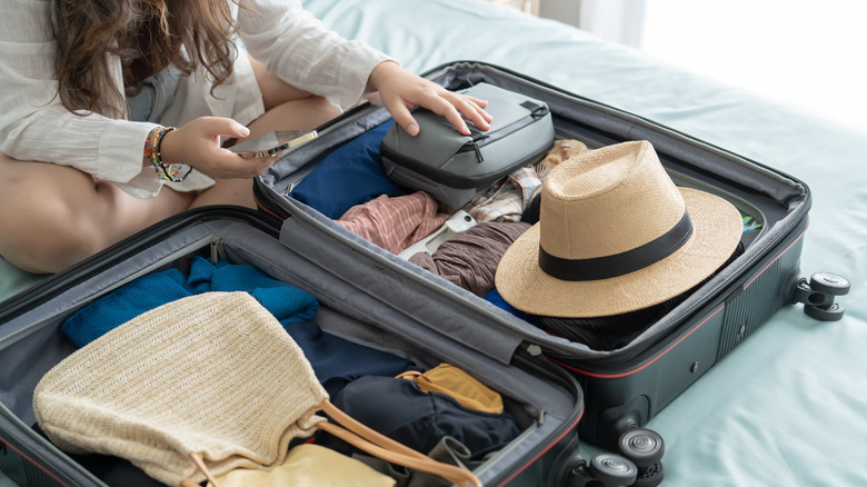 woman packing suitcase