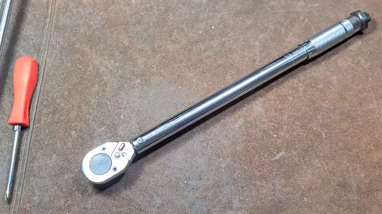 torque wrench and screwdriver on table