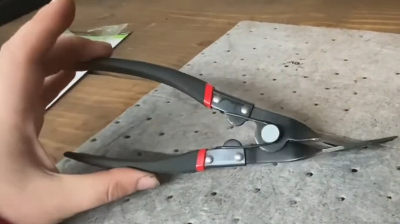 hand holding panel clip pliers