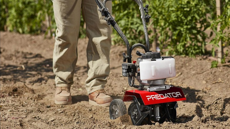 person using predator tiller