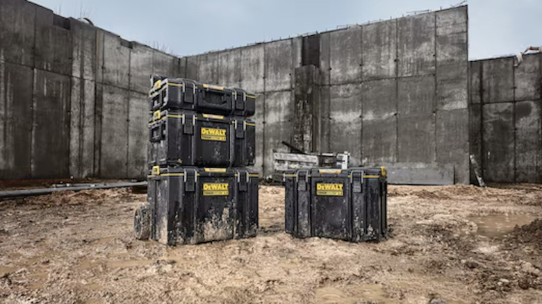 Four DeWalt tool boxes upright in a construction site