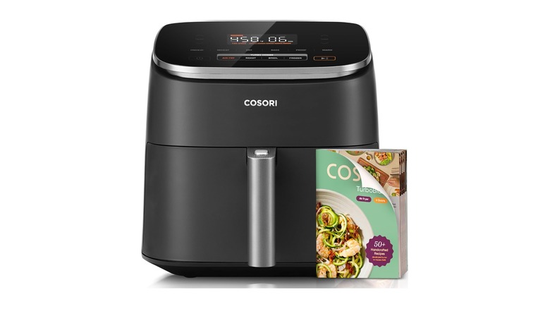 Stock photo of a black air fryer appliance with cookbook