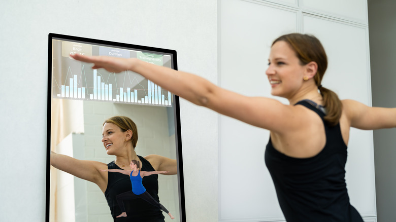 Woman using fitness mirror