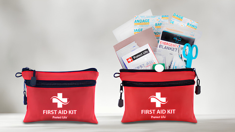 First aid kit set with zipper open and emergency items popping out