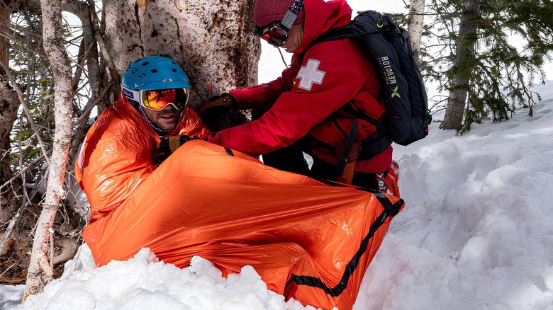 Someone using a emergency bivy on snow
