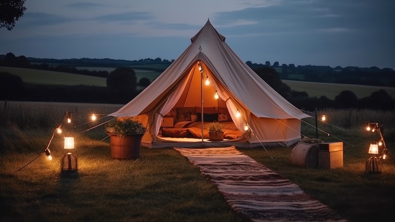 large luxury tent and electric lights on campsite