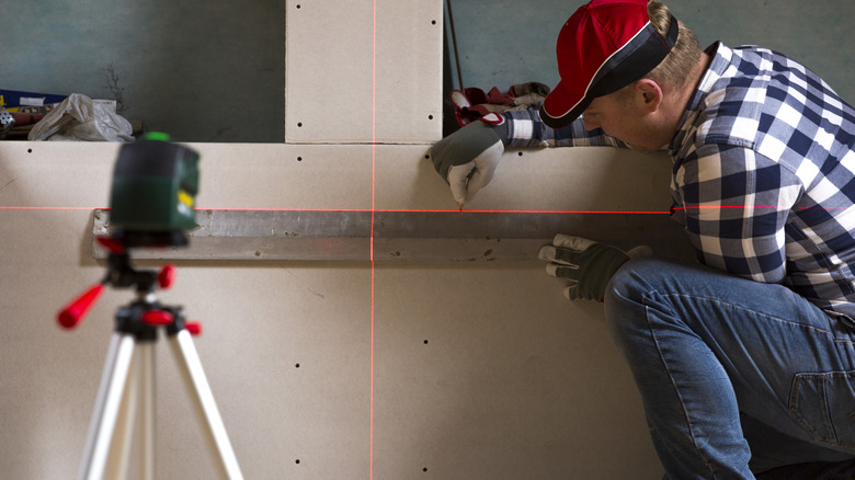 doing layout work with a laser level on drywall