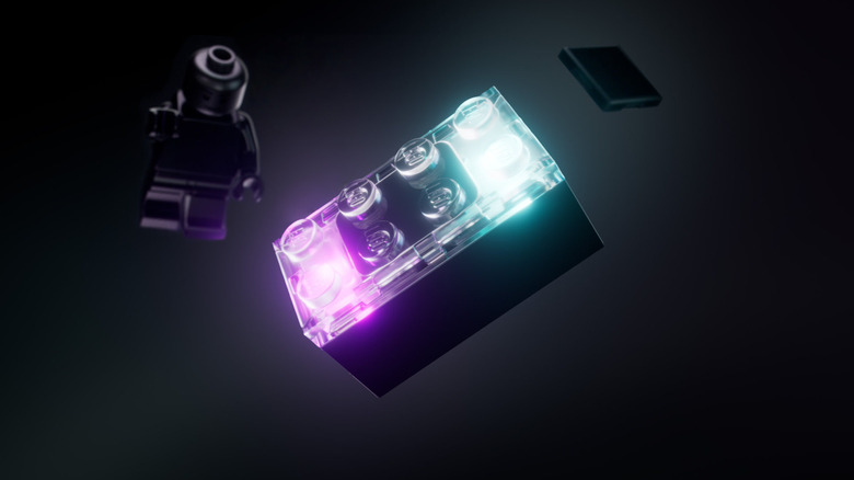 Lego smart brick glowing with a black figurine and tag in the background