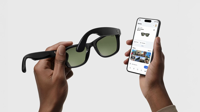 person holding a pair of Meta glasses with its app open on an iPhone