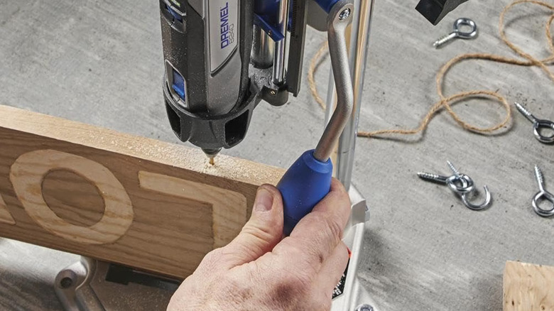 Dremel Rotary Tool Workstation being used to drill in a precise hole into wood