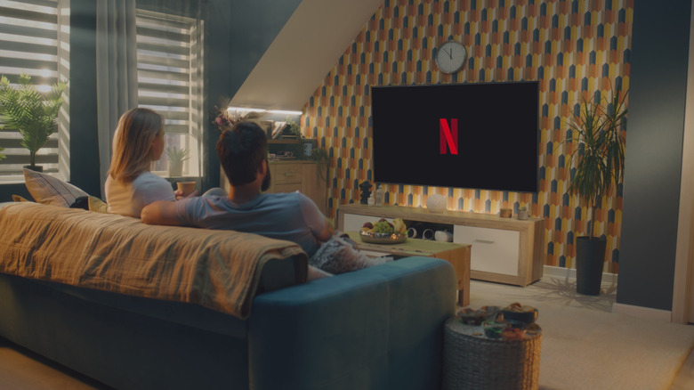 Couple watching Netflix in living room
