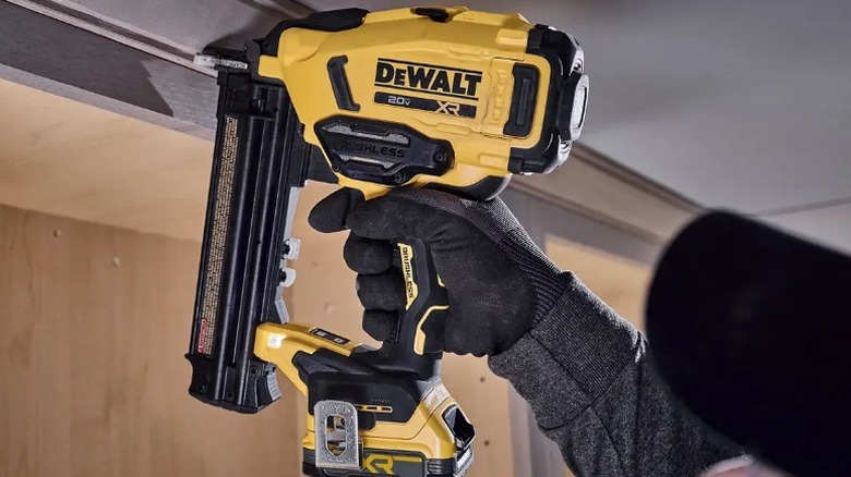 Person using DeWalt 20V Max XR Cordless 18-gauge Brad Nailer on door frame