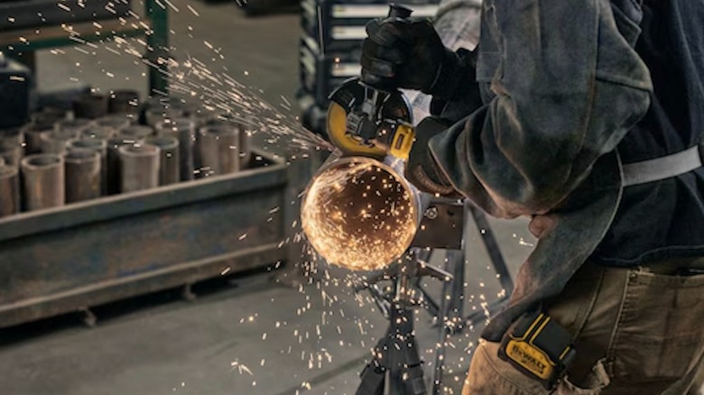 DeWalt Atomic 20V Max Cordless 4 ½-inch Angle Grinder with Paddle Switch in use
