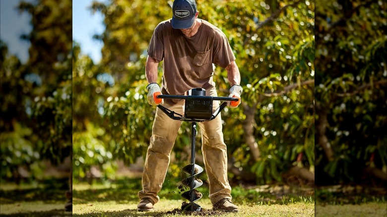 Person using an Atlas 80V cordless auger