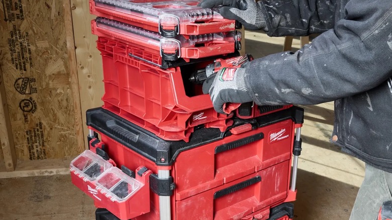 A person reaching into their Milwaukee Packout storage stack.