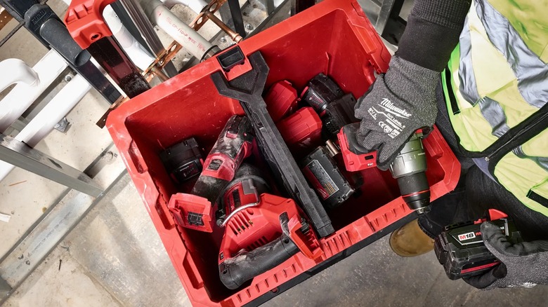 A person reaching into a Milwaukee Packout crate.