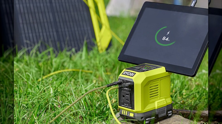 Solar panel powering a 18V One+ 200W Power Source/Charger that is charging a tablet