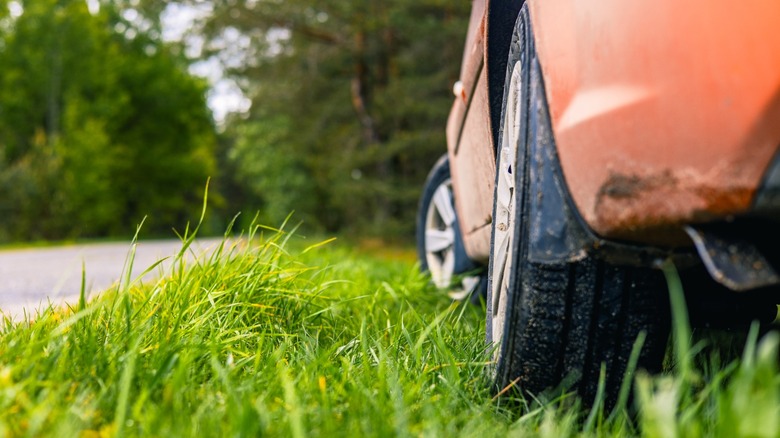 an orange car parked on the grass