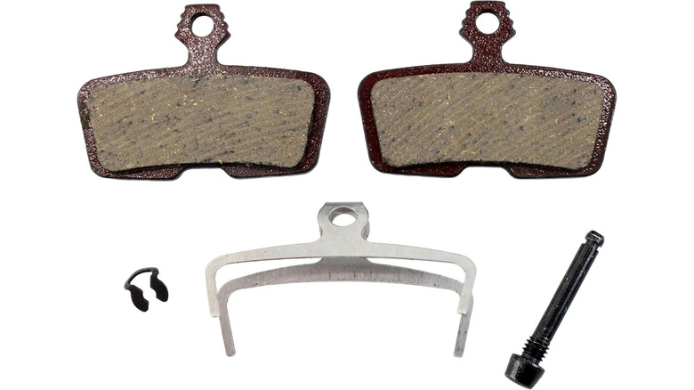 A pair of organic brake pads with associated hardware