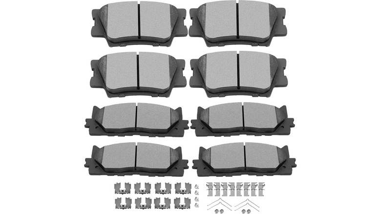 A set of eight brake pads with associated hardware
