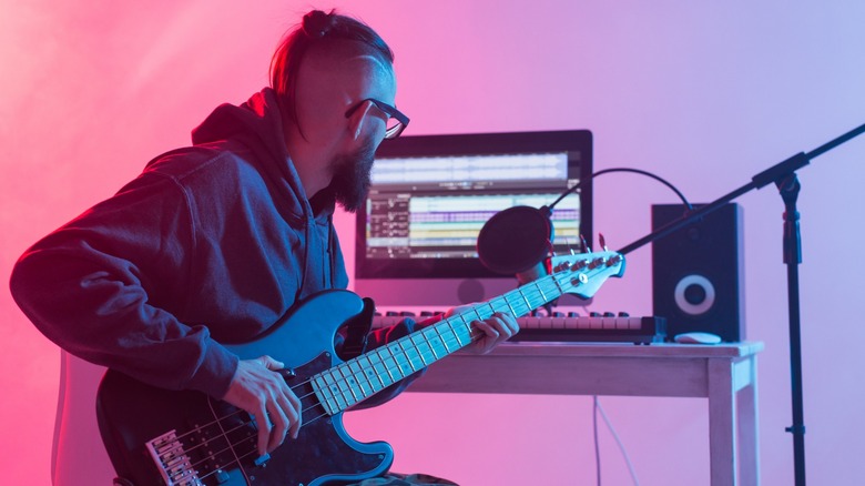 bass player in home studio environment