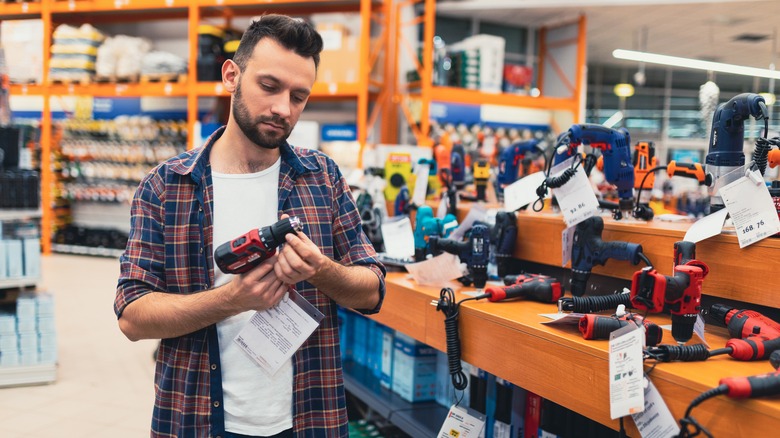 Man looking at tools in a hardware store