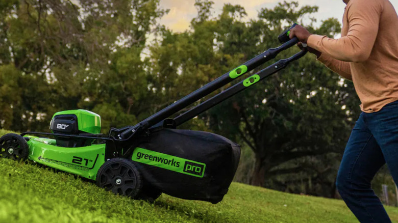 Greenworks electric mower being pushed uphill