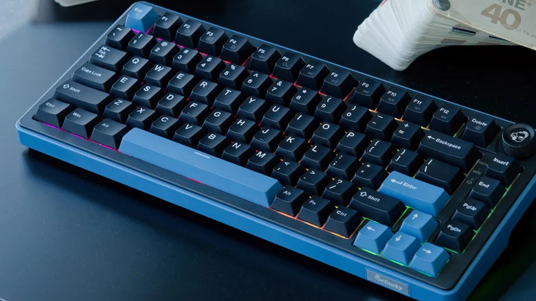 The Ducky OK-M mechanical keyboard with blue tones on a black surface