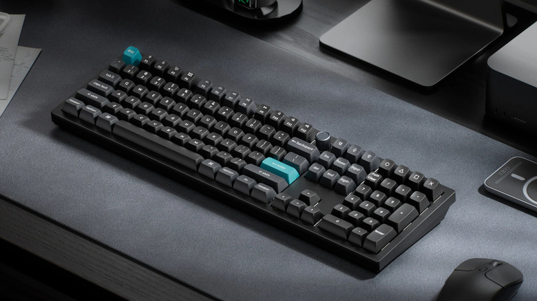 A black Keychron Q6 Ultra 8K keyboard next to a mouse on a desk mat