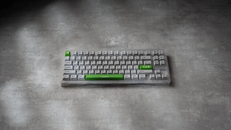 A Wooting 80HE keyboard with a few green buttons on a gray surface