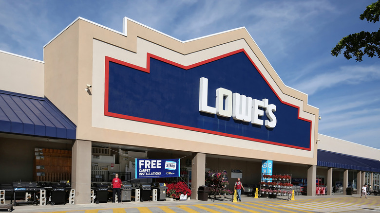 a Lowe's storefront with employees working