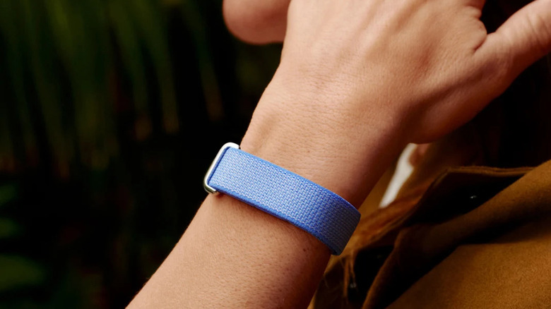 A person wearing the Google Fitbit Air in Blue color