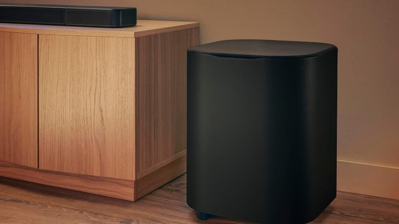 JBL Bar 1300 mk2 soundbar and subwoofer on a wood cabinet and wood flooring